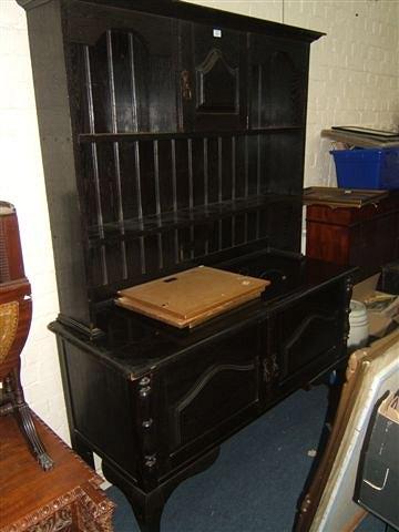 Appraisal: An ebonised oak dresser circa with plate rack above and