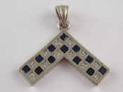 Appraisal: A white metal tests carat gold sapphire and diamond pendant