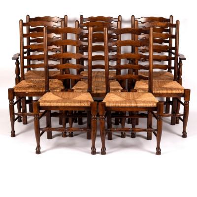 Appraisal: Eight elm ladder back chairs with rush seats on turned