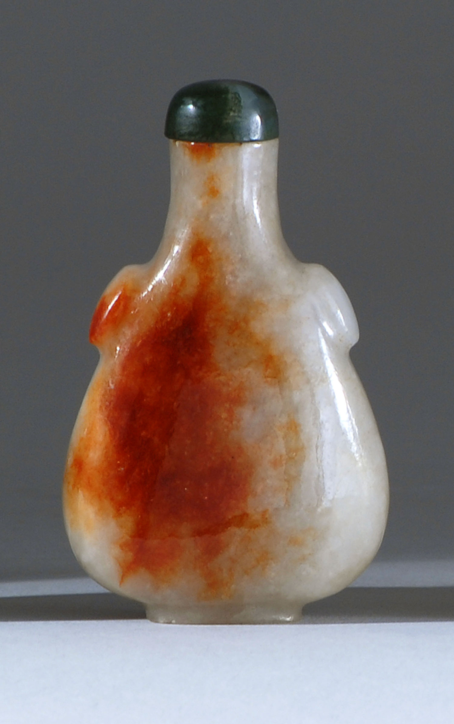 Appraisal: WHITE AND RUSSET JADE SNUFF BOTTLE Late th CenturyIn pear