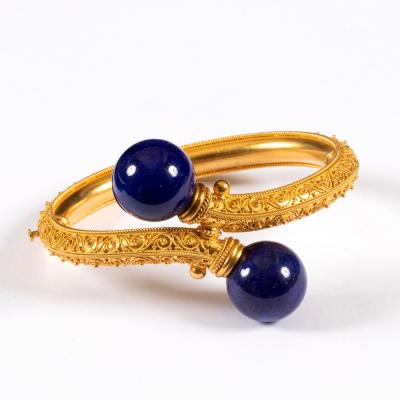 Appraisal: An Archaeological revival gold and lapis lazuli bangle circa of