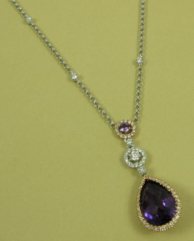 Appraisal: AMETHYST DIAMOND AND K GOLD PENDANT NECKLACE featuring a pear-shaped