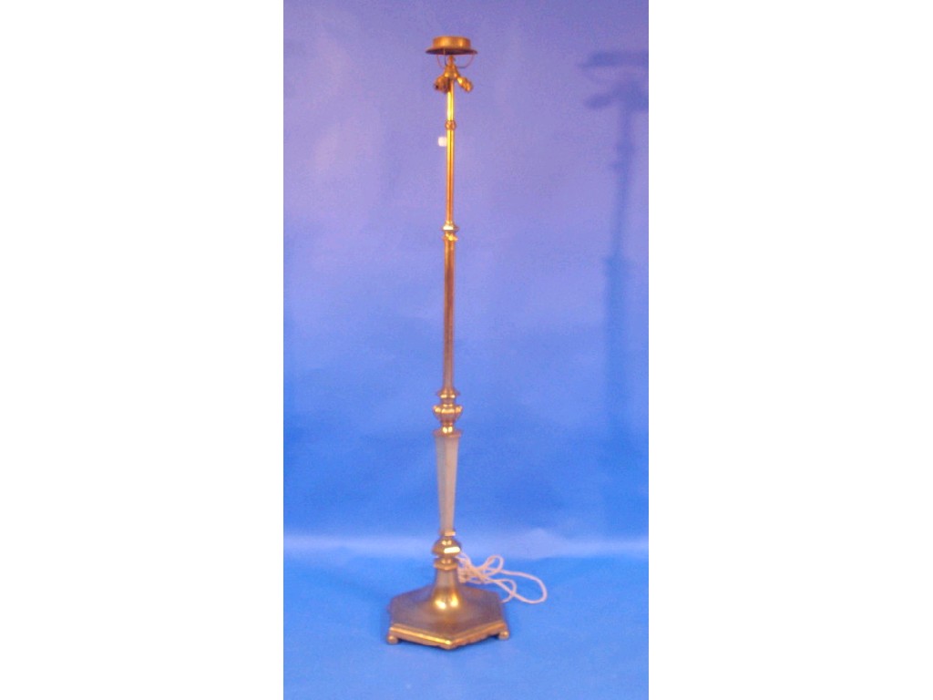 Appraisal: An adjustable brass floor lamp with hexagonal column and base