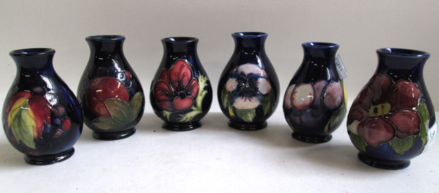 Appraisal: SIX MOORCROFT POTTERY VASES hand painted under glaze in various