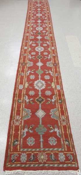 Appraisal: HAND KNOTTED ORIENTAL RUNNER Indo-Persian stylized floral pattern on rose