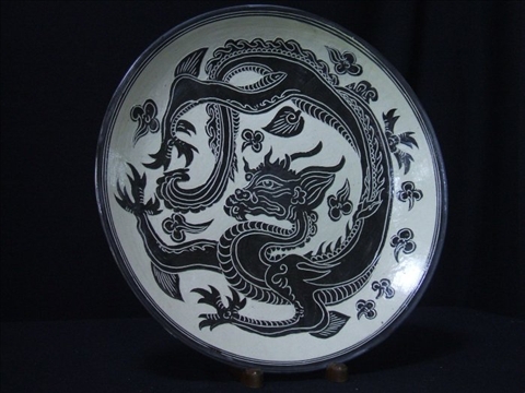 Appraisal: CHINESE PROVINCIAL CARVED CHARGER Clack dragon amidst clouds reproduction -