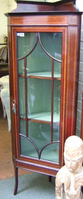 Appraisal: An Edwardian mahogany and line inlaid corner cupboard the glazed