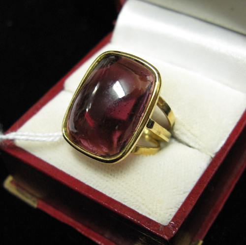 Appraisal: GARNET AND EIGHTEEN KARAT GOLD SOLITAIRE RING bezel set with