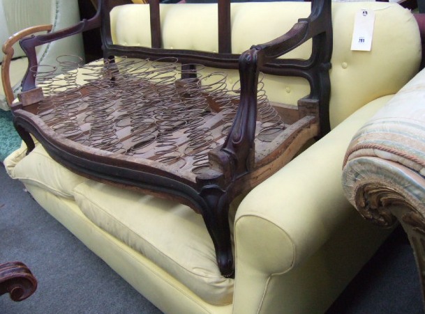 Appraisal: A Victorian mahogany framed button back sofa with rollover arms