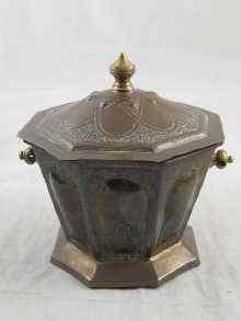 Appraisal: A Moroccan octagonal lidded brass box hand embossed with Islamic