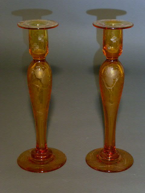 Appraisal: Pair of amber glass candlesticks with etched grape and vine