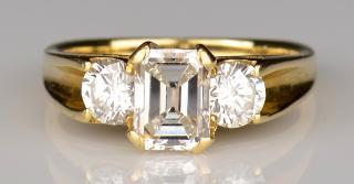 Appraisal: K K three-stone diamond ring containing one emerald cut center