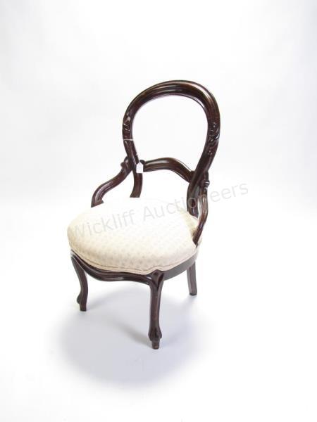 Appraisal: An antique Victorian balloon back chair with hip rests rosewood