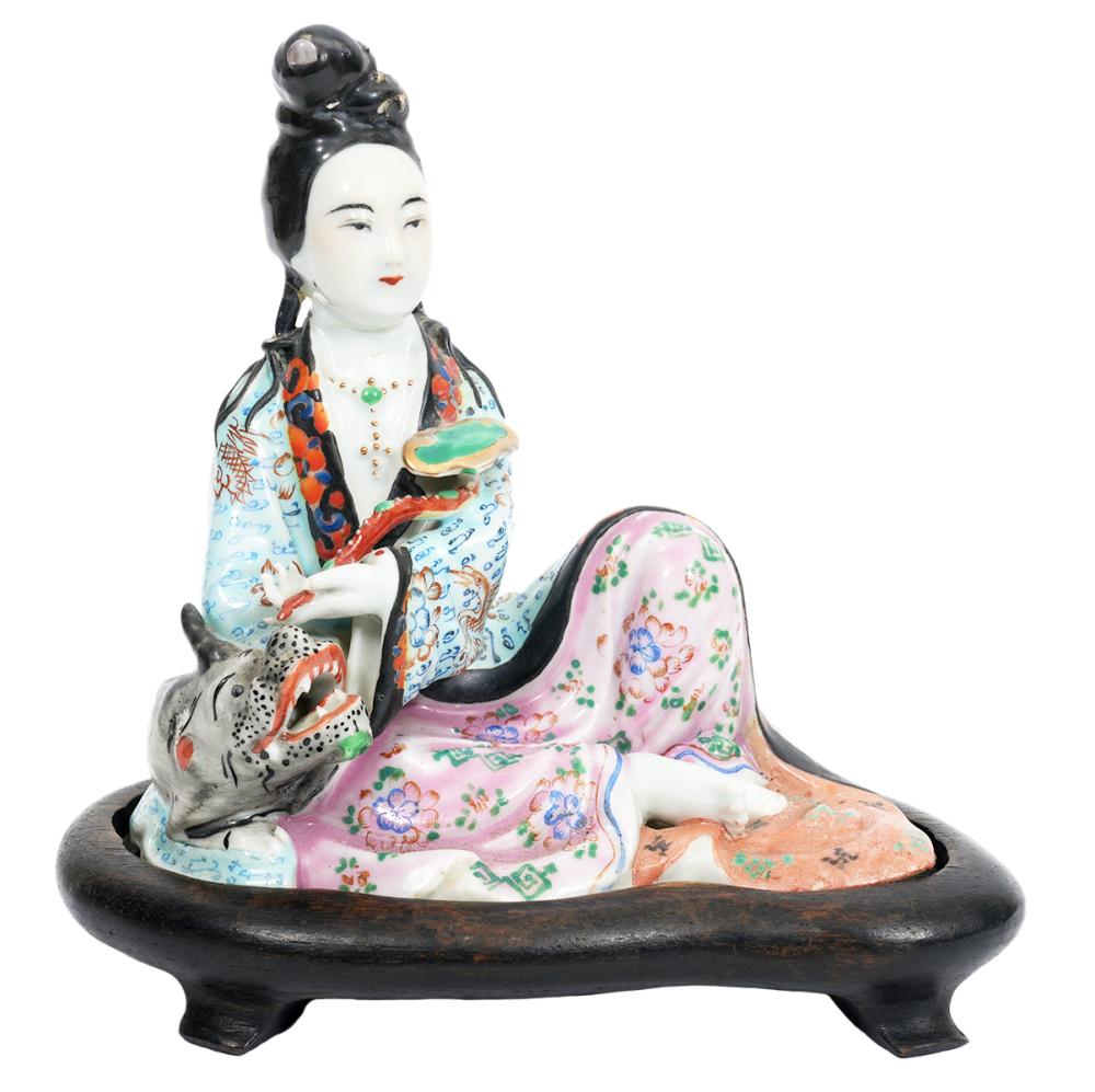 Appraisal: CHINESE PORCELAIN FIGURE WITH DRAGON ON PLINTHChinese porcelain seated figure