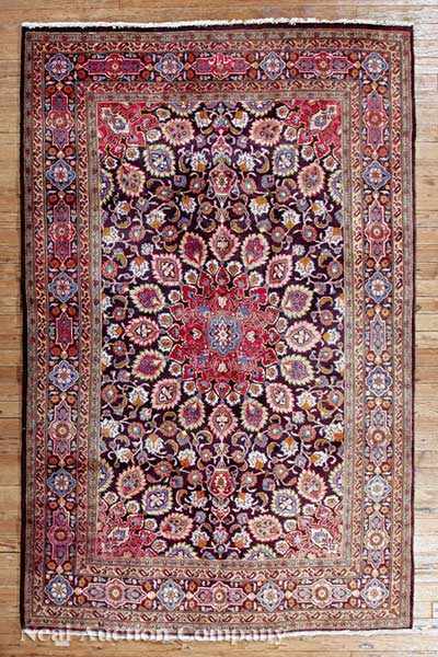 Appraisal: A Mashad Carpet signed crimson ground central floral medallion small