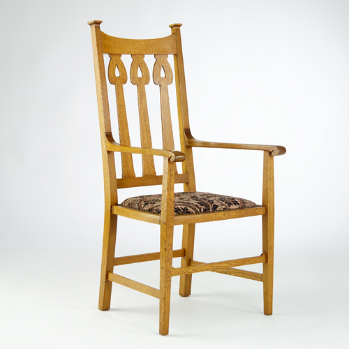 Appraisal: British Arts Crafts armchair its back slats with spade-shaped cut-outs