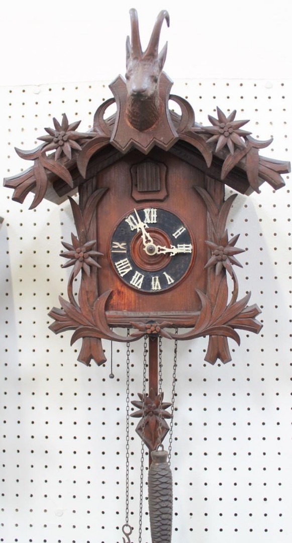 Appraisal: A Black Forest style cuckoo clock with goats head and