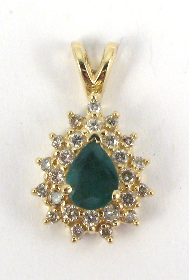 Appraisal: EMERALD AND DIAMOND PENDANT k yellow gold centering a pear-cut