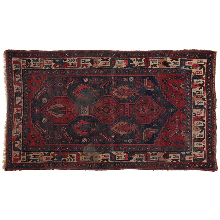 Appraisal: Persian tribal rug c central design in blue red and