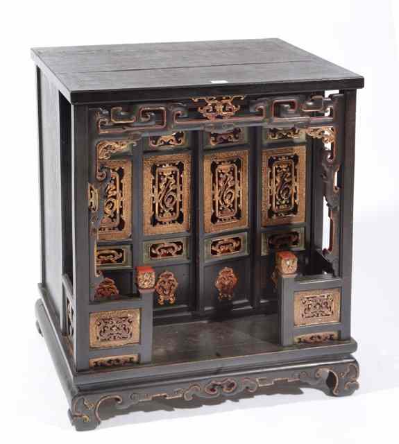 Appraisal: A JAPANESE BLACK AND GOLD LACQUERED SHRINE CABINET the carved