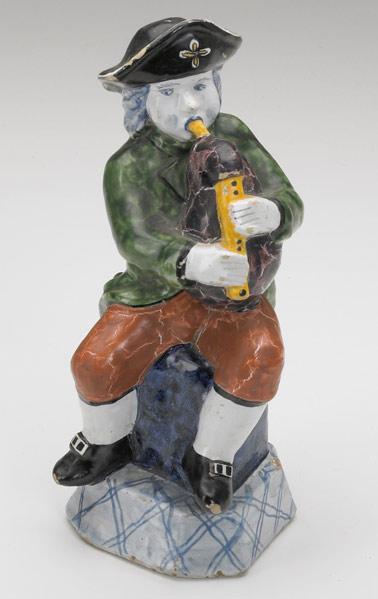 Appraisal: DELFT FIGURE Bagpipe player with polychrome decoration th C Some