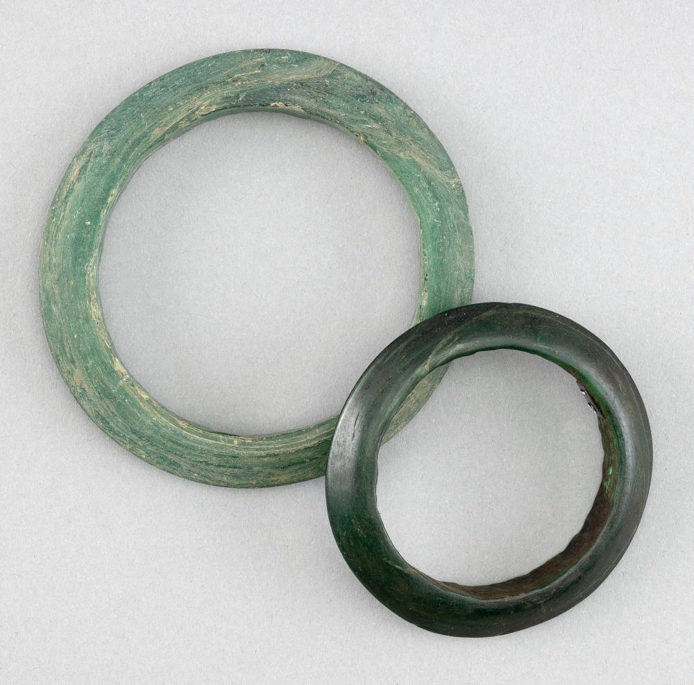 Appraisal: TWO ARCHAIC GREEN JADE BANGLESTWO ARCHAIC GREEN JADE BANGLES One