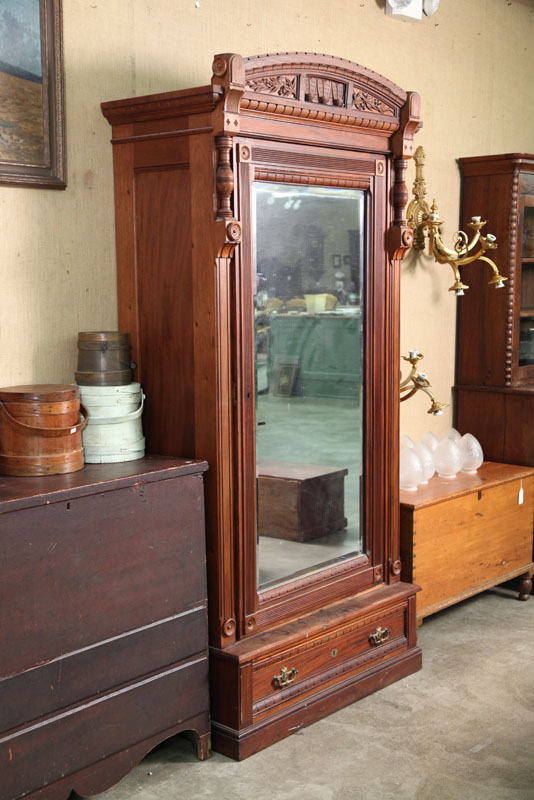 Appraisal: WARDROBE Walnut having dentil carved accents turned and incised columns