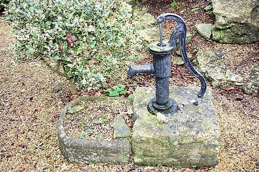 Appraisal: A pump on a stone and a D shaped trough