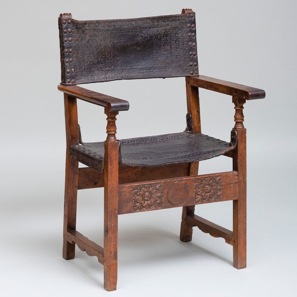 Appraisal: Iberian Carved Walnut and Embossed Leather Armchair Marked with a