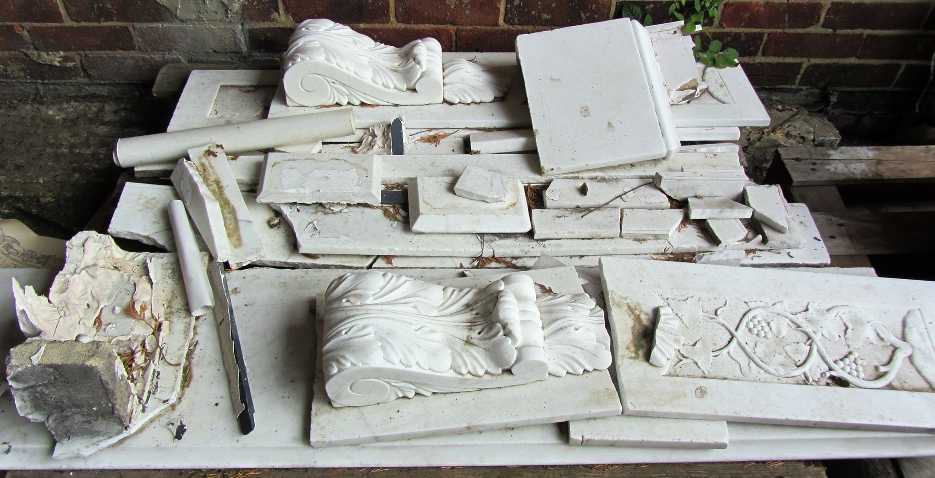 Appraisal: A th century white marble fire surround with carved vine