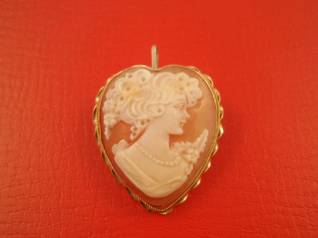 Appraisal: A heart shaped shell cameo brooch in frame stamped K