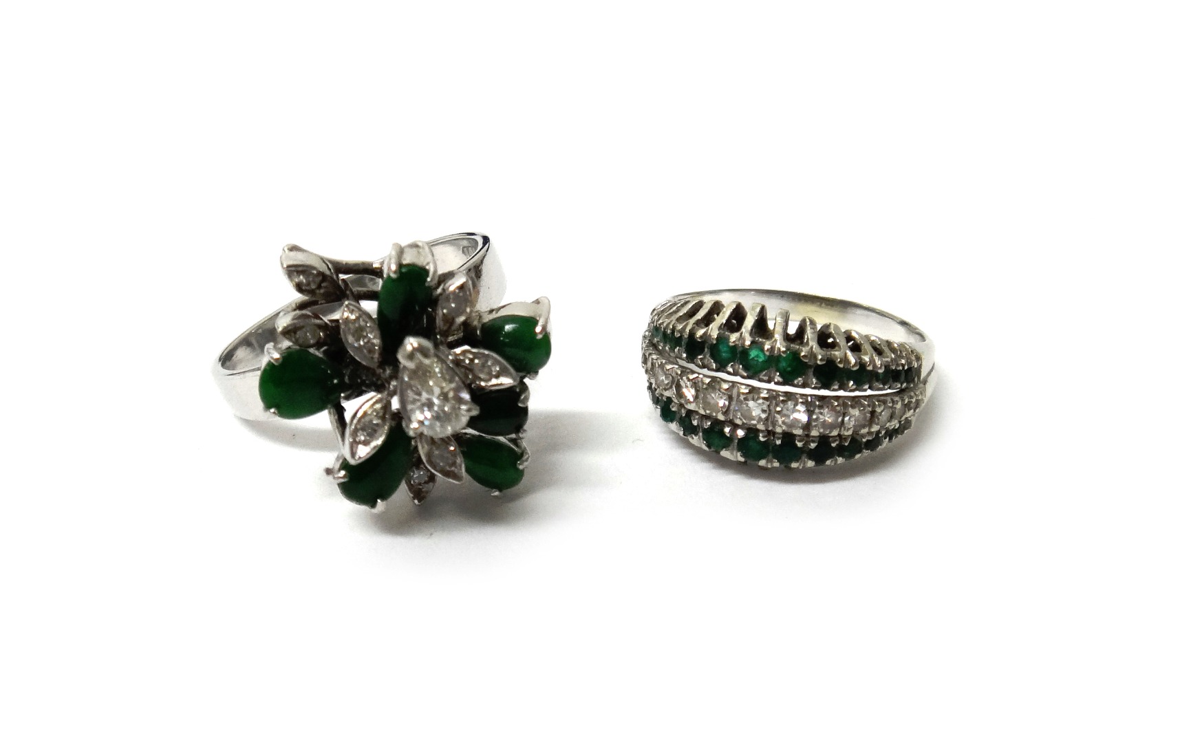 Appraisal: A diamond and emerald ring mounted with a row of