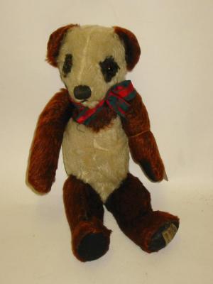 Appraisal: A Merrythought Patti Panda teddy bear covered in dark cinnamon