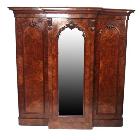 Appraisal: A Victorian walnut breakfront wardrobe the projected moulded cornice over