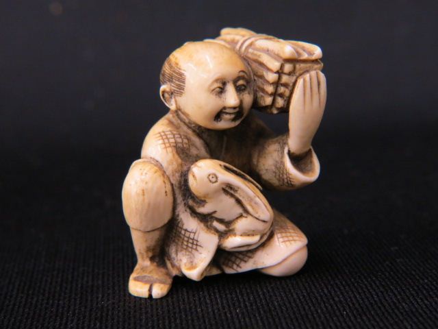 Appraisal: Carved Ivory Netsuke of Manwith load of firewood a rabbit