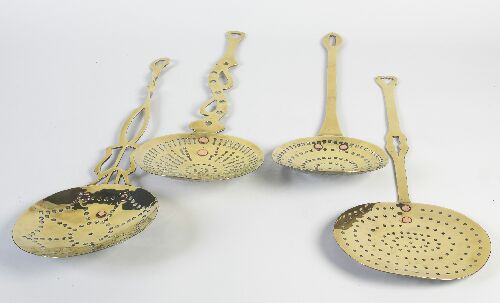 Appraisal: A group of four various th century brass cream skimmers