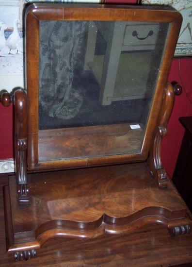 Appraisal: A Victorian mahogany swing frame toilet mirror on a serpentine