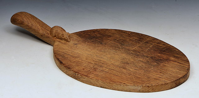 Appraisal: Robert Thompson British - of KilburnMouseman oak cheese boardadzedcarved with