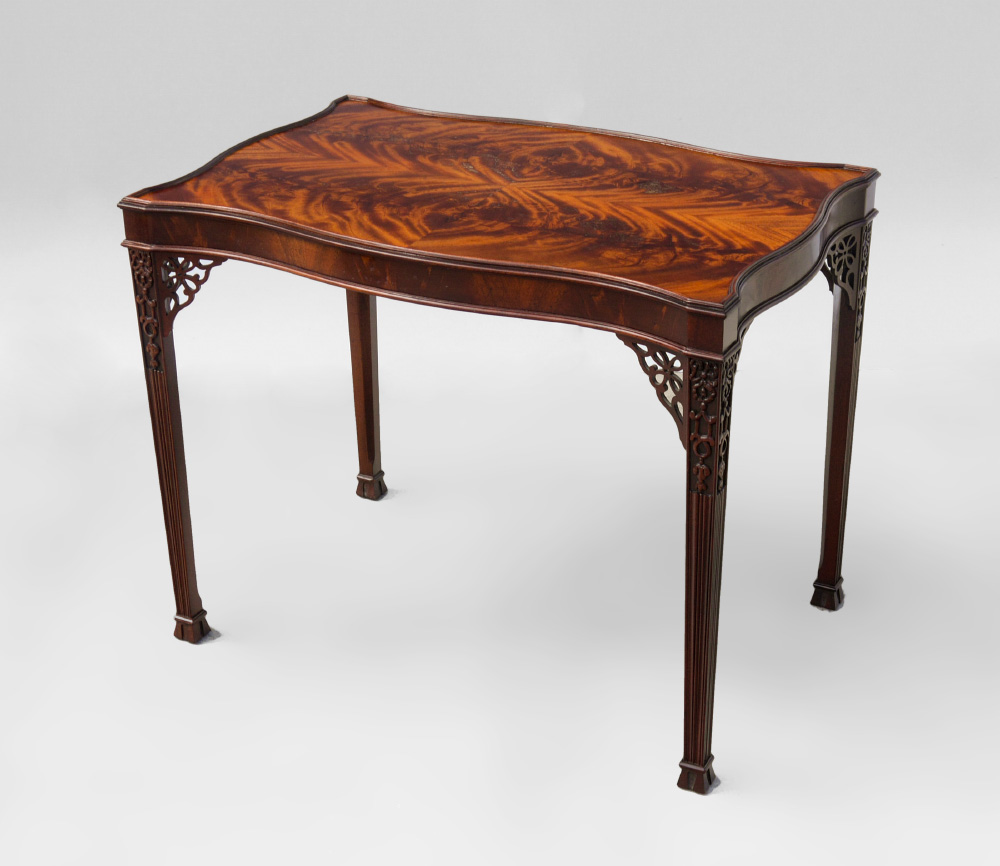 Appraisal: BAKER CHIPPENDALE STYLE OCCASIONAL TABLE Shaped top with book matched