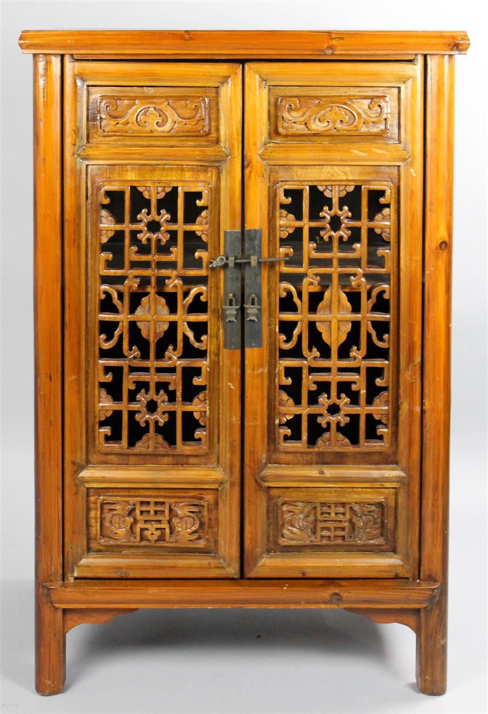 Appraisal: CHINESE CABINET WITH CARVED AND PIERCED DOORS having double doors