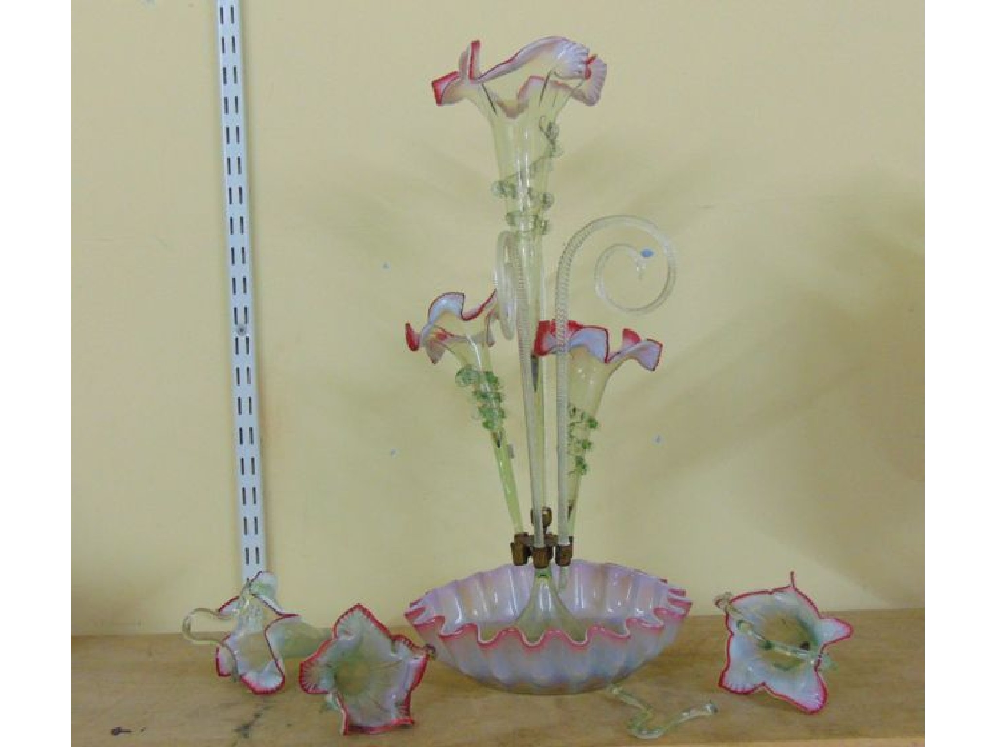 Appraisal: A Victorian epergne with fluted basin central trumpet flanked by