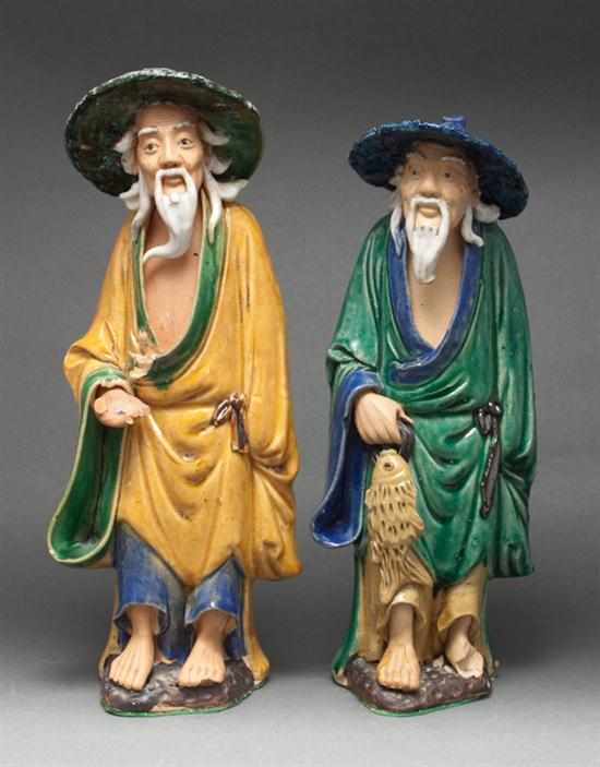 Appraisal: Two Chinese Export glazed terracotta figures th century man holding