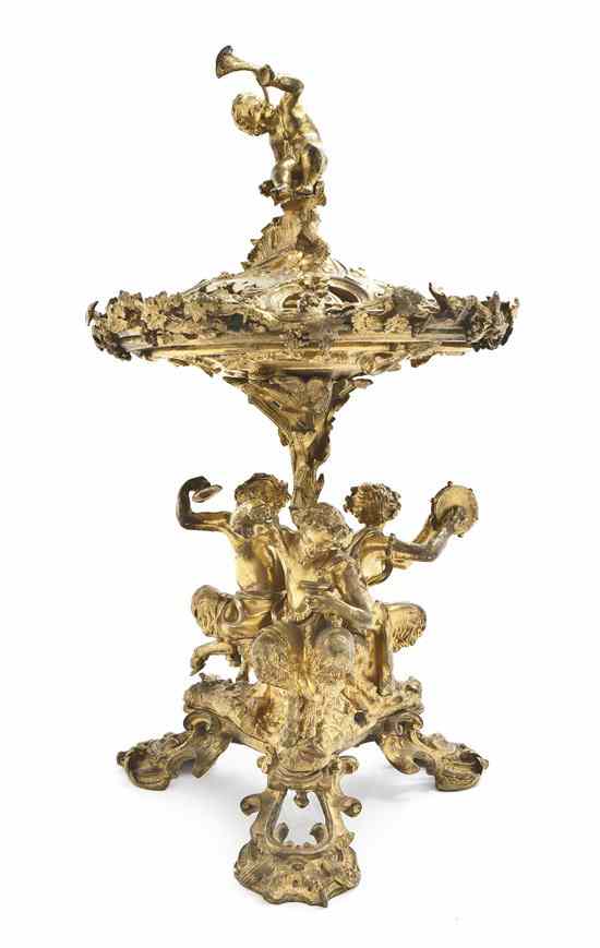 Appraisal: A French Gilt Bronze Figural Plate Rack the cover with