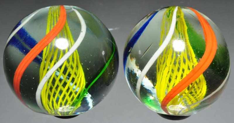 Appraisal: Lot of Same Cane Latticino Marbles Description Includes two marbles