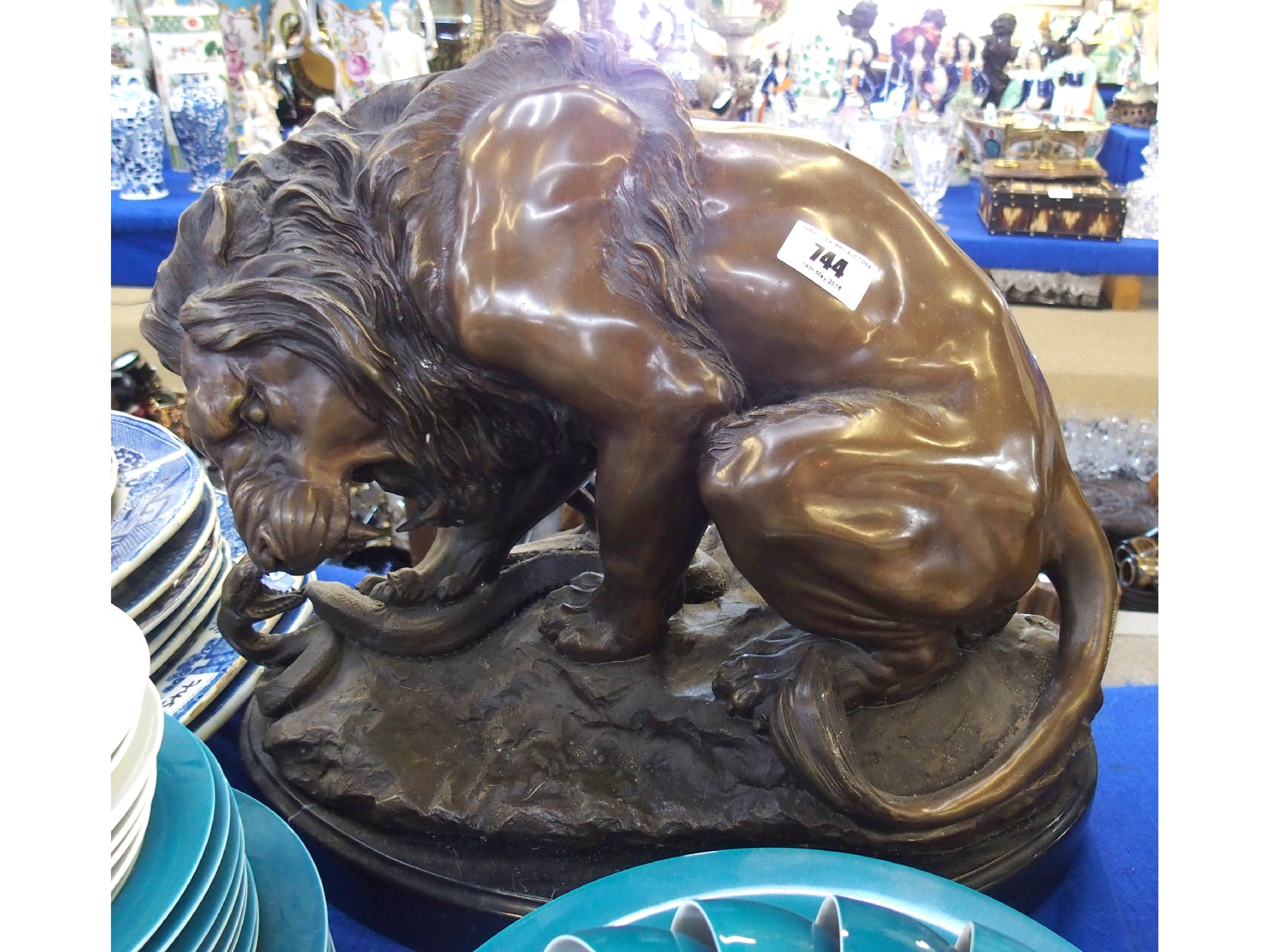 Appraisal: Bronzed resin model of a lion and snake