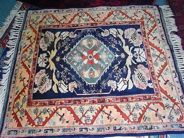 Appraisal: A TURKISH WOOL BLUE GROUND RUG with central green medallion