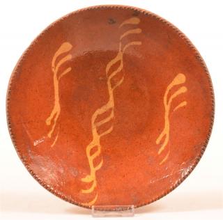 Appraisal: th Century Redware Yellow Slip Decorated Plate Coggle wheel edge