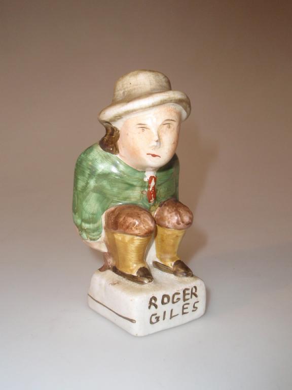 Appraisal: A thC humorous Staffordshire figure of Roger Giles exposing his