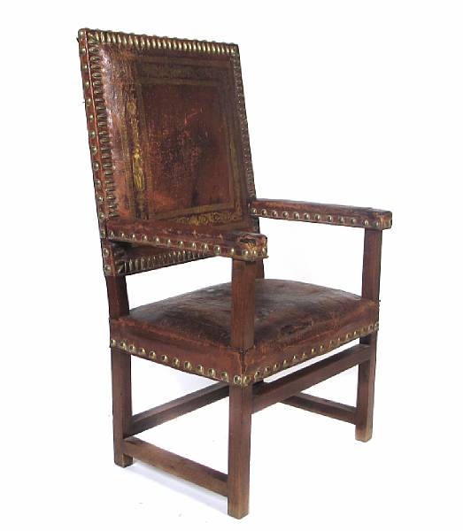 Appraisal: A Spanish style leather upholstered armchair th century losses restoration