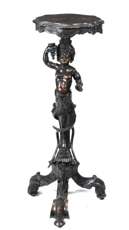 Appraisal: A VENETIAN CARVED WALNUT TORCHERE the serpentine top supported by